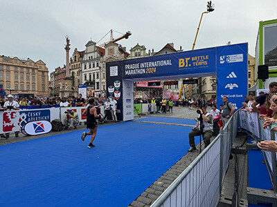 Runner crossing the finish line at the 2024 Prague Marathon