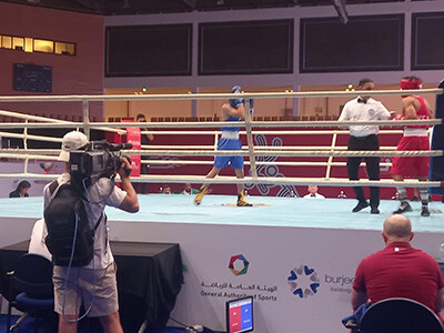 Camera operator at the Youth Games outside the ring