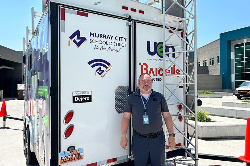 Jason Eyre in front of a trailer at UEN Tech Summit 2025