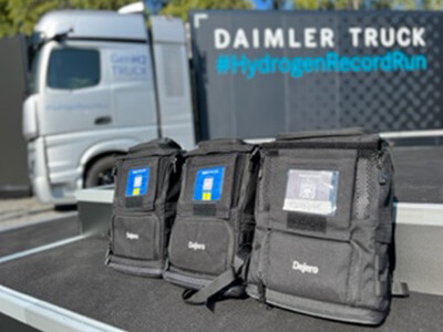 Dejero EnGo units in backpacks in front of truck